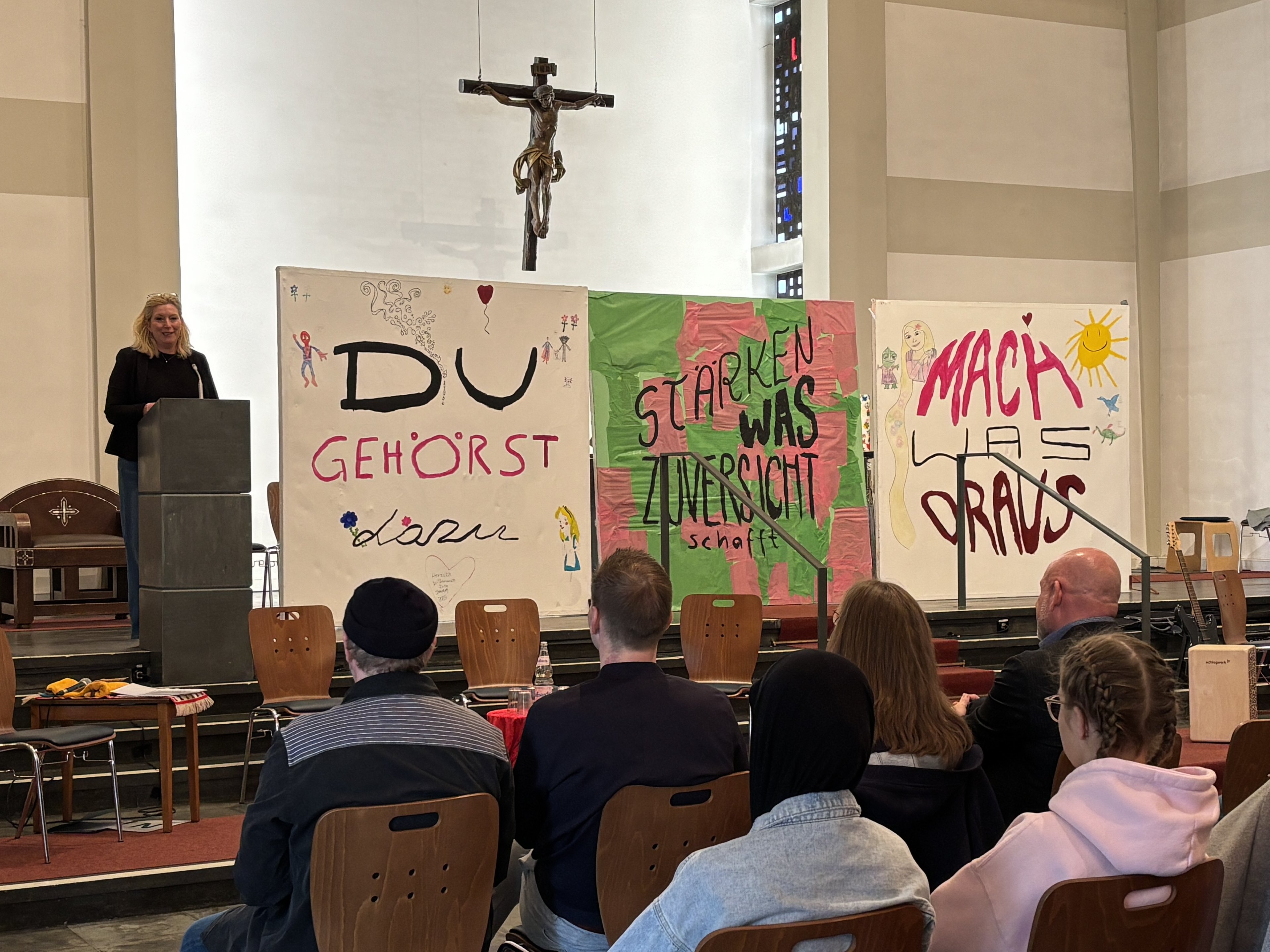 Bürgermeisterin Julia Jacob spricht am Rednerpult in der Kirche ein Grußwort.