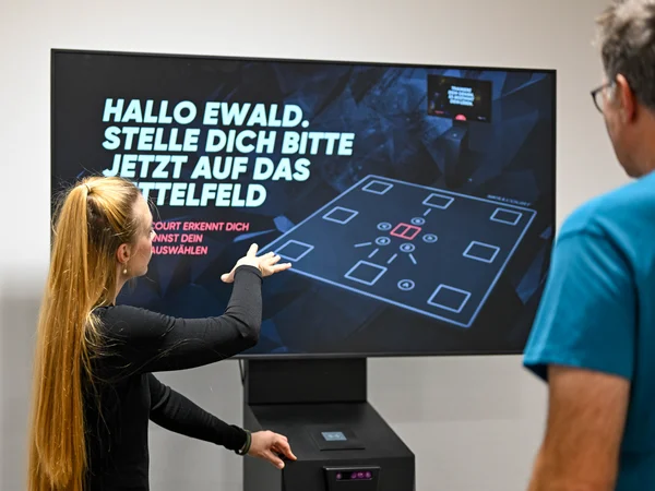 Mitarbeiterin weist Sportler beim Skillcourt ein